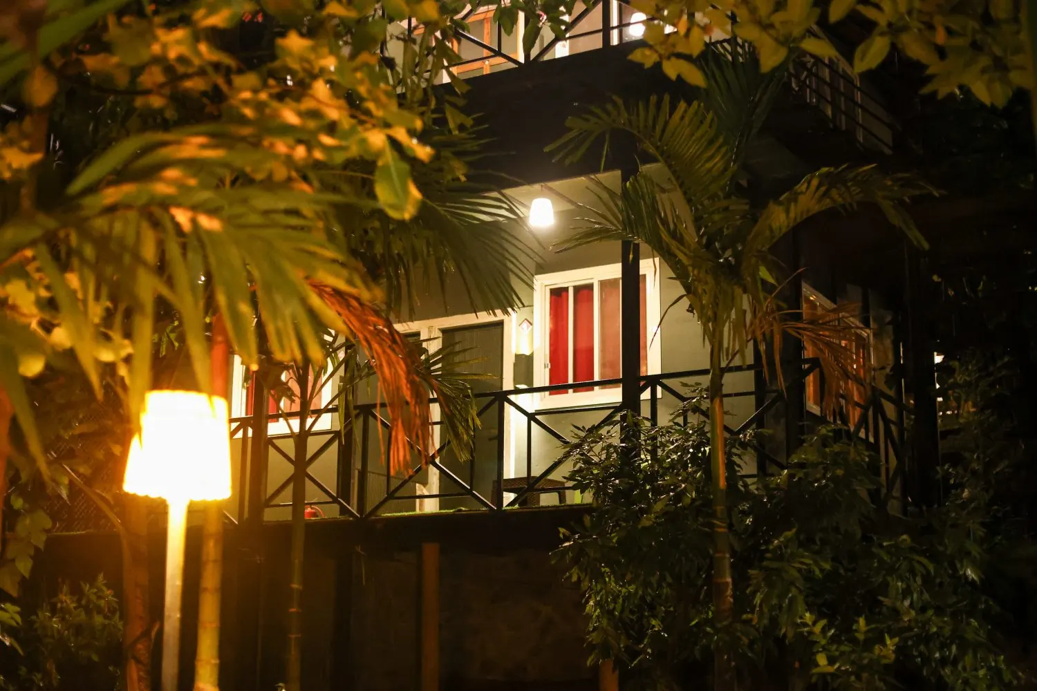 Chalet verandah lit by a lamp in the evening